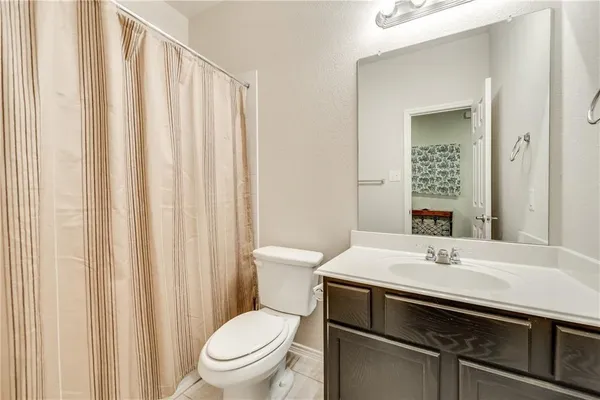 a bathroom with a sink toilet and mirror
