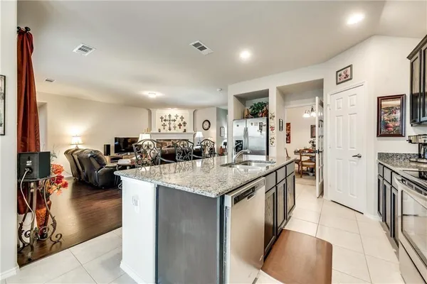 a kitchen with counter top space appliances and cabinets