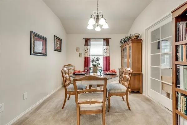 a view of a dining room with furniture and chandelier