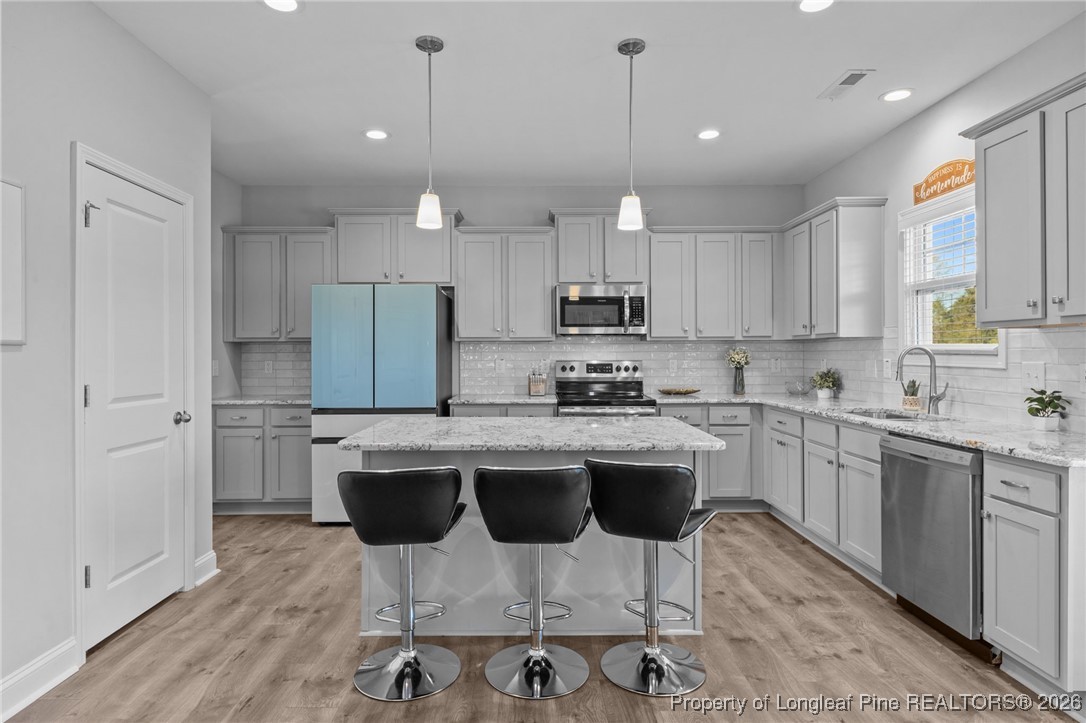 298 Turkey Trot Lane Raeford, NC 28376 - Photo 11 of 43 a kitchen with kitchen island granite countertop a sink and white appliances