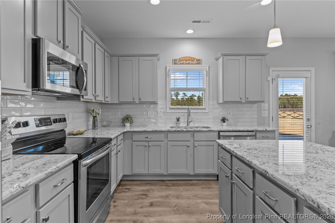 298 Turkey Trot Lane Raeford, NC 28376 - Photo 13 of 43 a kitchen with a sink stove and cabinets
