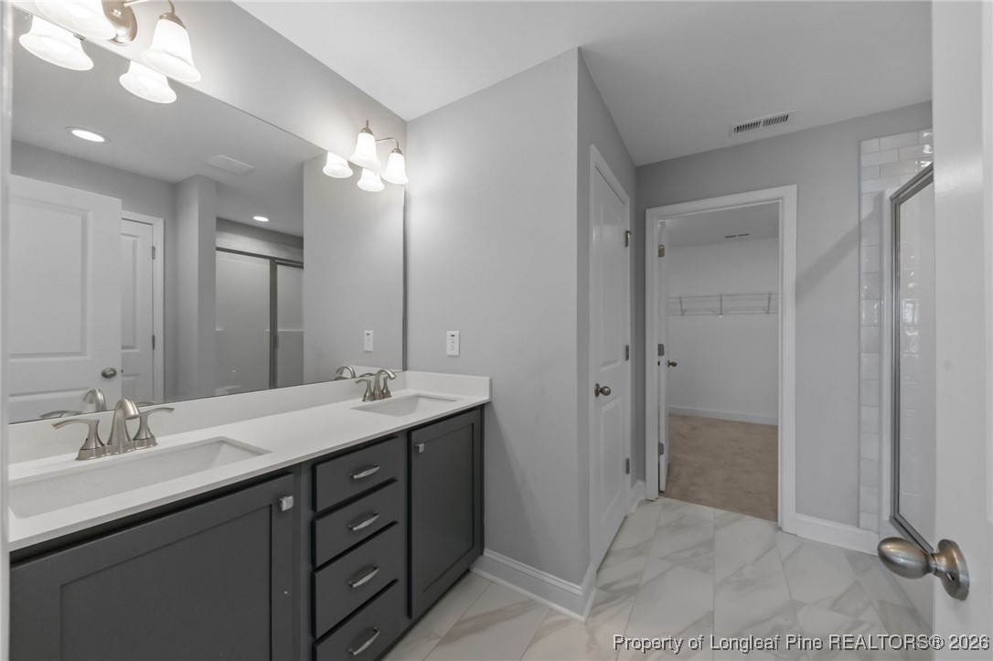298 Turkey Trot Lane Raeford, NC 28376 - Photo 25 of 43 a bathroom with a double vanity sink and a mirror