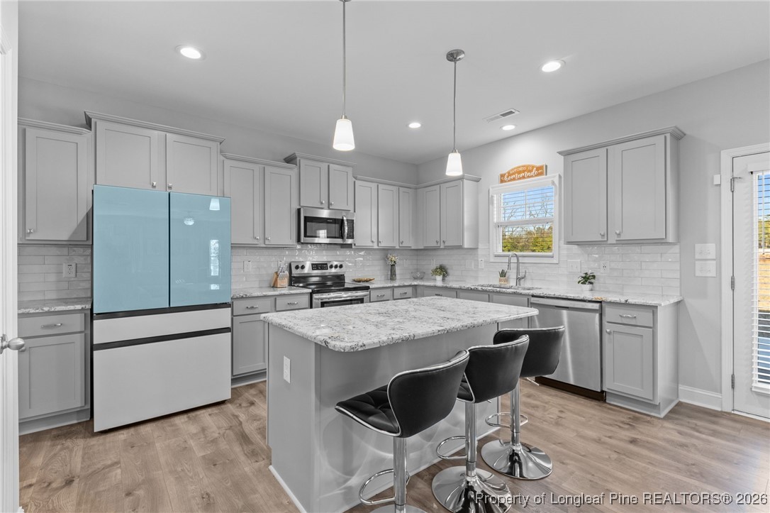 298 Turkey Trot Lane Raeford, NC 28376 - Photo 5 of 43 a kitchen with kitchen island granite countertop a sink a center island and appliances
