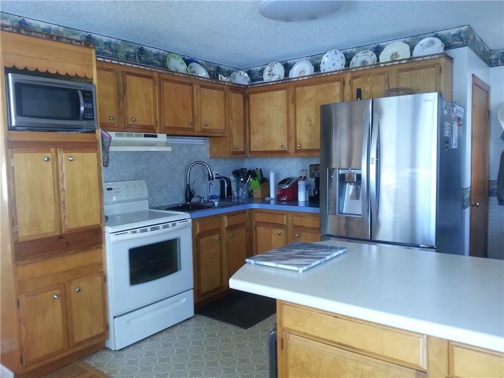 107 Dinsmore Road Sidney, ME 04330 - Photo 3 of 25 KITCHEN OPENS TO DINING ROOM