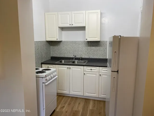 a kitchen with stainless steel appliances white cabinets and a stove