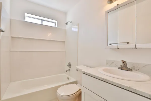 a bathroom with a sink a toilet and bathtub