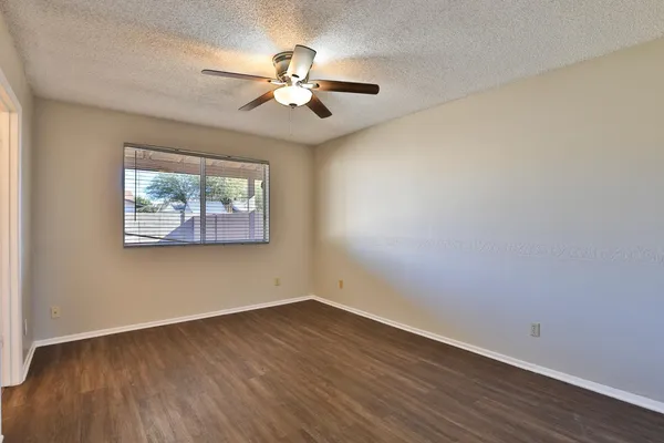 a view of empty room with wooden floor