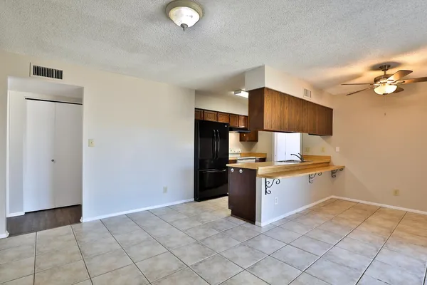 a kitchen with stainless steel appliances granite countertop a refrigerator and a stove top oven