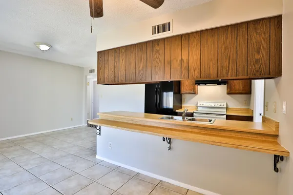 a kitchen with a sink cabinets and appliances