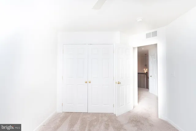 a view of a room with a ceiling fan and a window