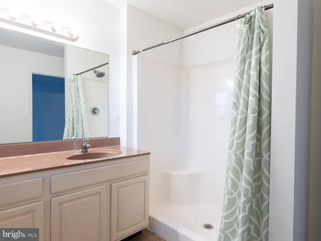 a view of a room with a ceiling fan