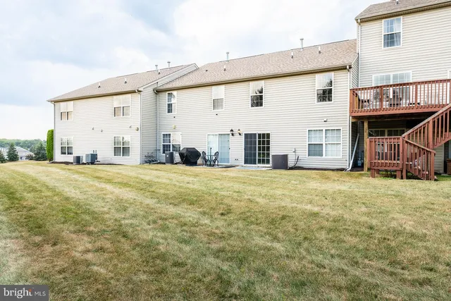 a aerial view of a brick house next to a brick building