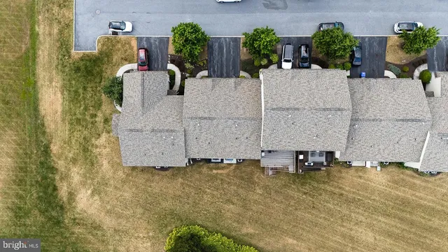 an aerial view of a house with garden space and street view