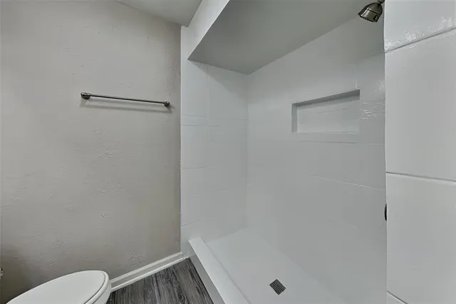 a bathroom with a shower and toilet