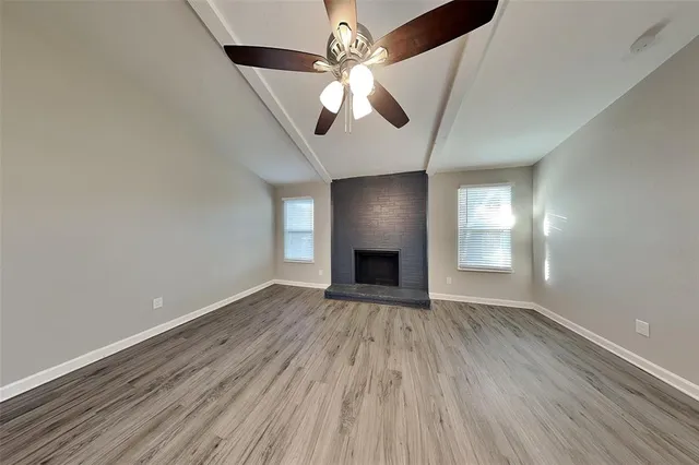 wooden floor in an empty room with a fireplace