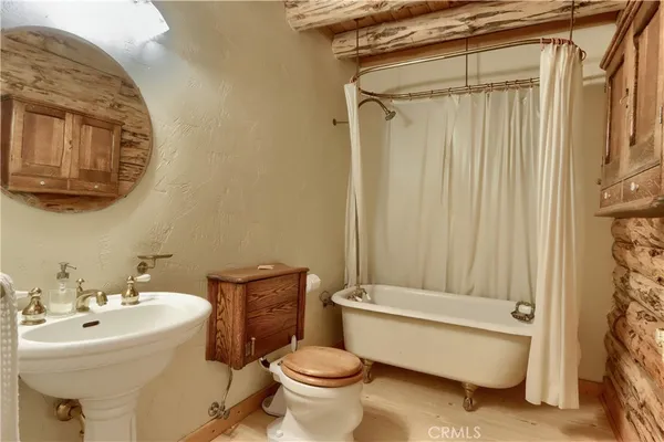 a bathroom with a granite countertop toilet sink and mirror
