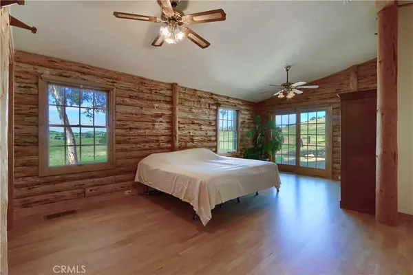 a view of a livingroom with a flesh screen tv and stairs