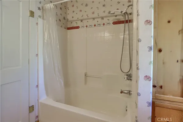 a bath tub sitting in a bathroom next to a window
