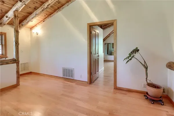 a view of a deck with wooden floor and outdoor seating