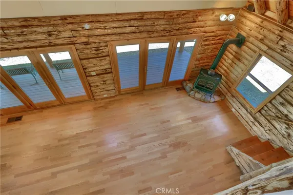 a front view of a house with yard and tree