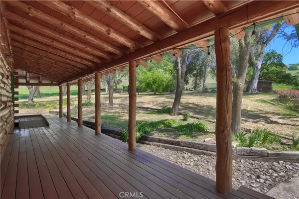 a view of a terrace with wooden floor and a lake view