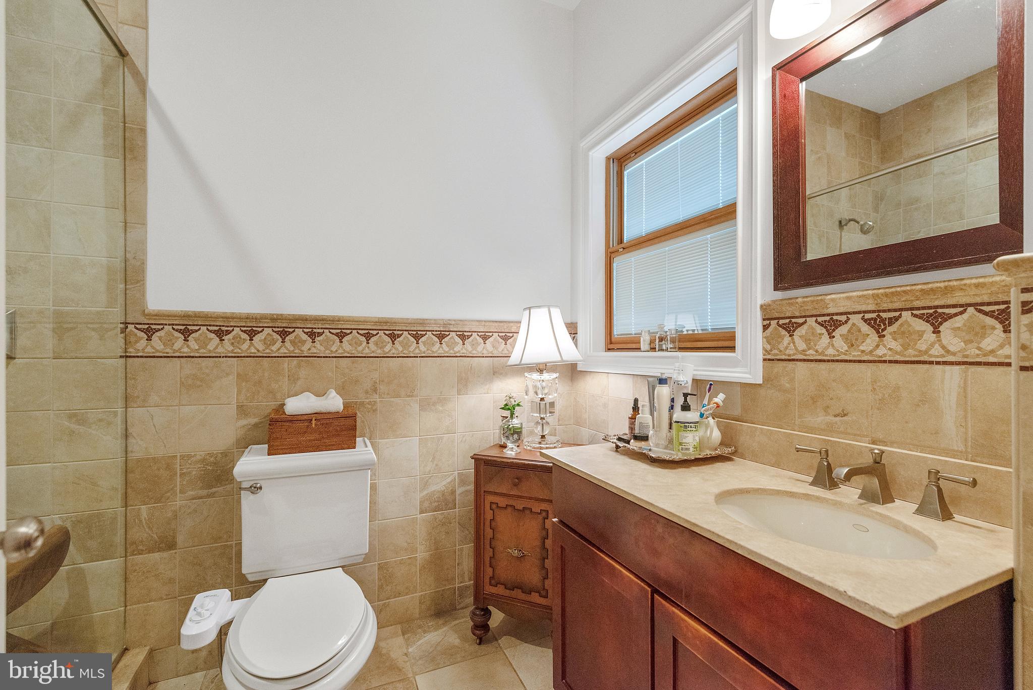608 South 9th Street, Unit 1 Philadelphia, PA 19147 - Photo 14 of 23 a bathroom with a granite countertop toilet sink and mirror