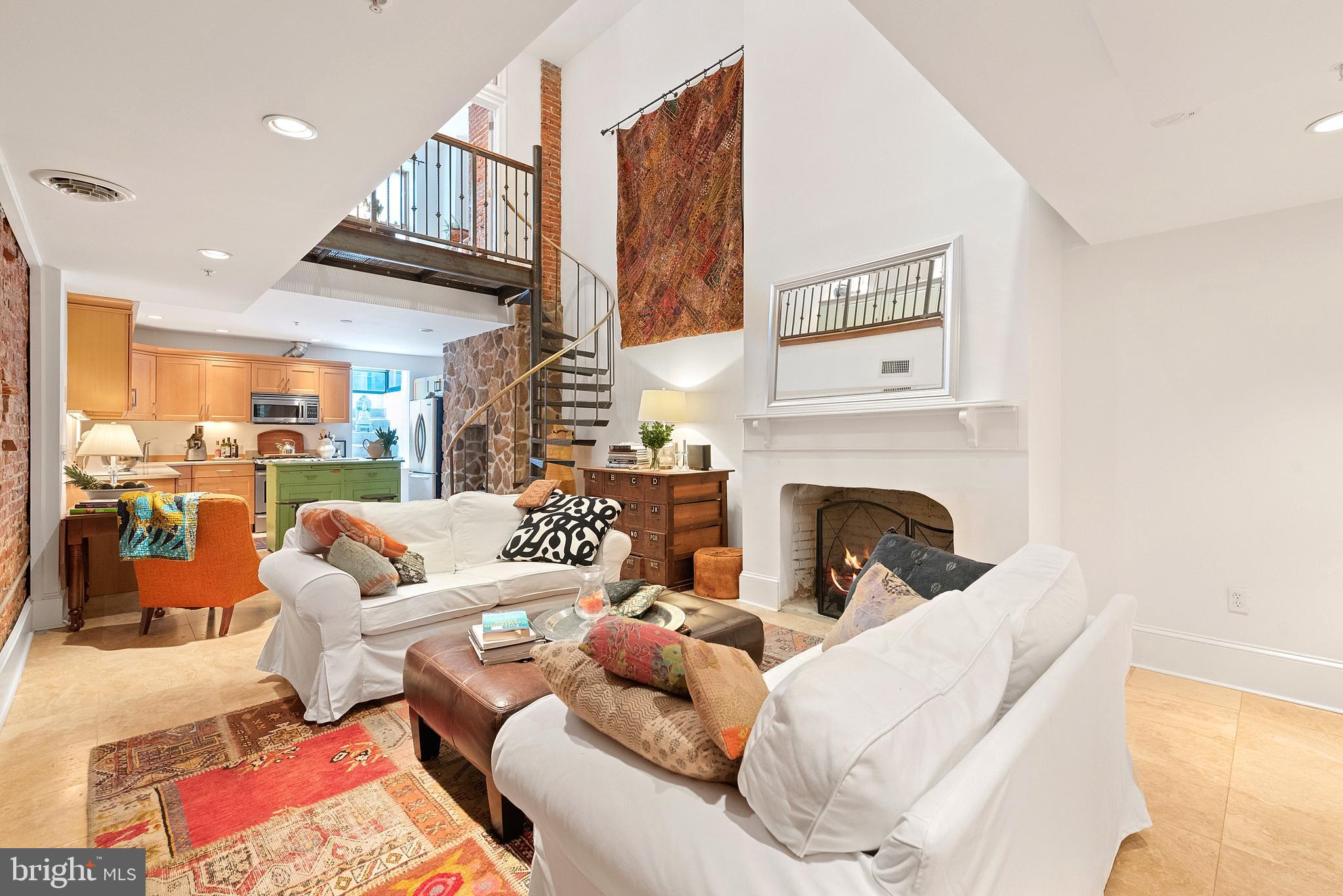 608 South 9th Street, Unit 1 Philadelphia, PA 19147 - Photo 4 of 23 a living room with furniture a fireplace and a kitchen view