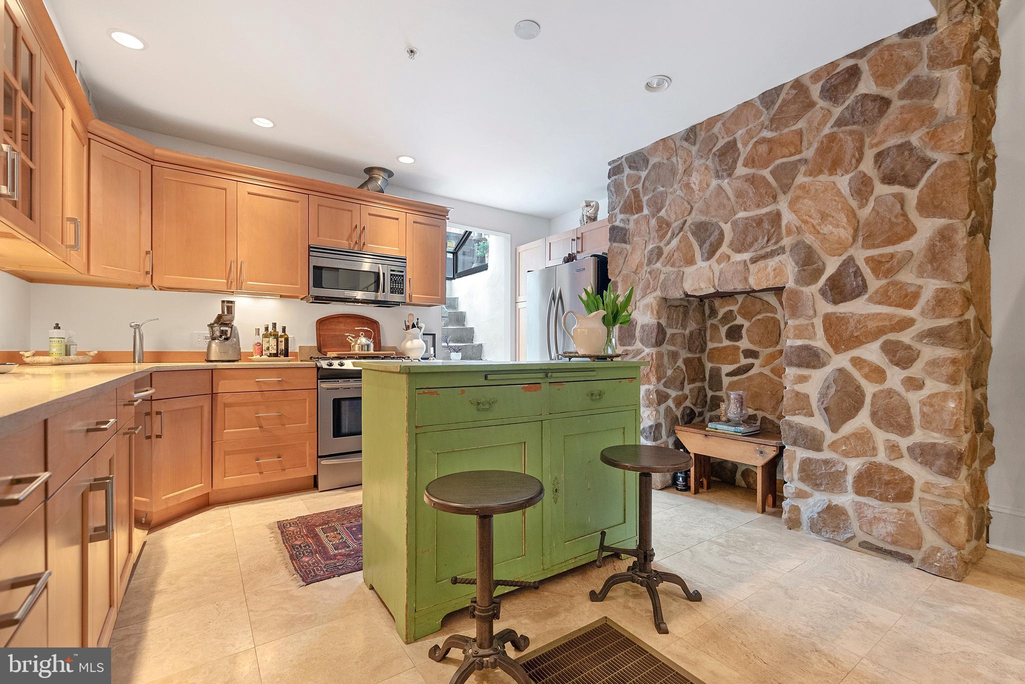 608 South 9th Street, Unit 1 Philadelphia, PA 19147 - Photo 5 of 23 a kitchen with cabinets and chairs