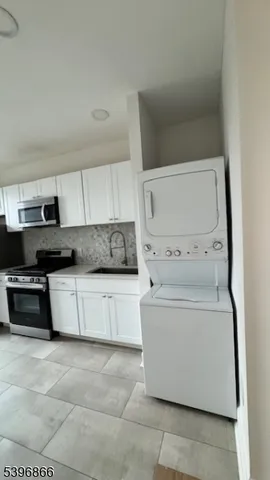 a kitchen with a stove and white cabinets
