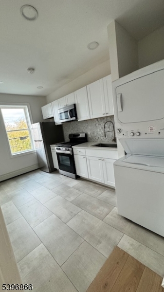 113 Broadway, Unit 1 Newark, NJ 07104 - Photo 5 of 8 a view of kitchen with cabinets and window