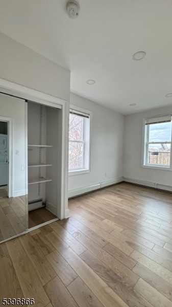113 Broadway, Unit 1 Newark, NJ 07104 - Photo 6 of 8 an empty room with wooden floor and window