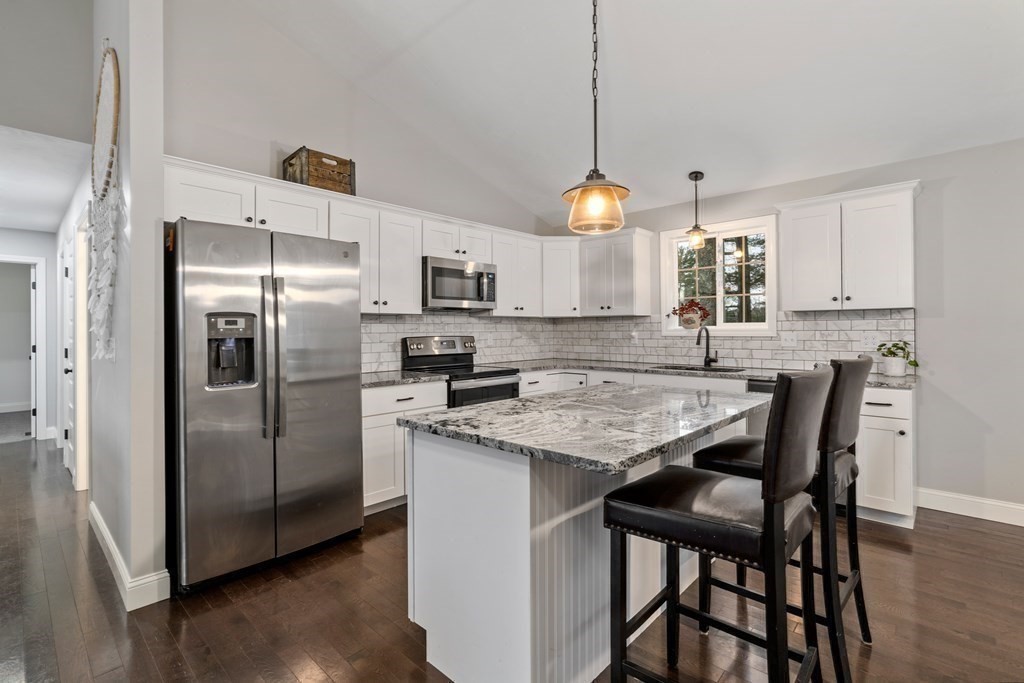 143 North Brookfield Road Barre, MA 01005 - Photo 12 of 31 a kitchen with stainless steel appliances granite countertop a table chairs a refrigerator a sink a stove a microwave and dining table