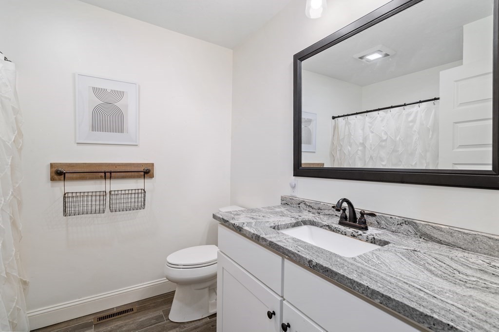 143 North Brookfield Road Barre, MA 01005 - Photo 27 of 31 a bathroom with a granite countertop toilet sink and mirror