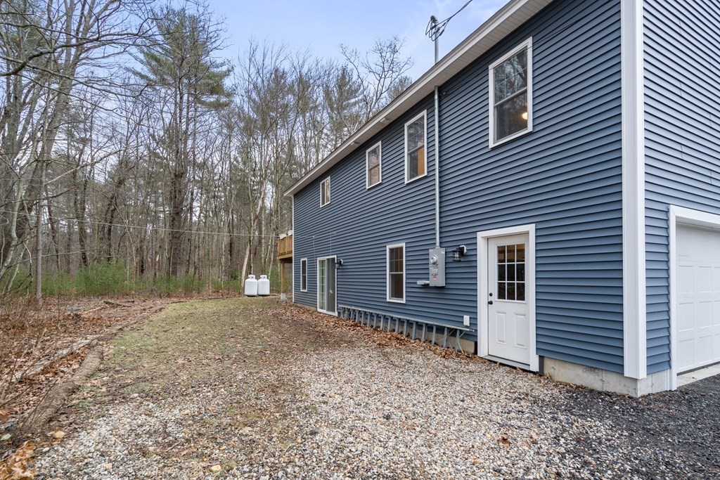 143 North Brookfield Road Barre, MA 01005 - Photo 10 of 31 a backyard of a house with wooden fence and large tree
