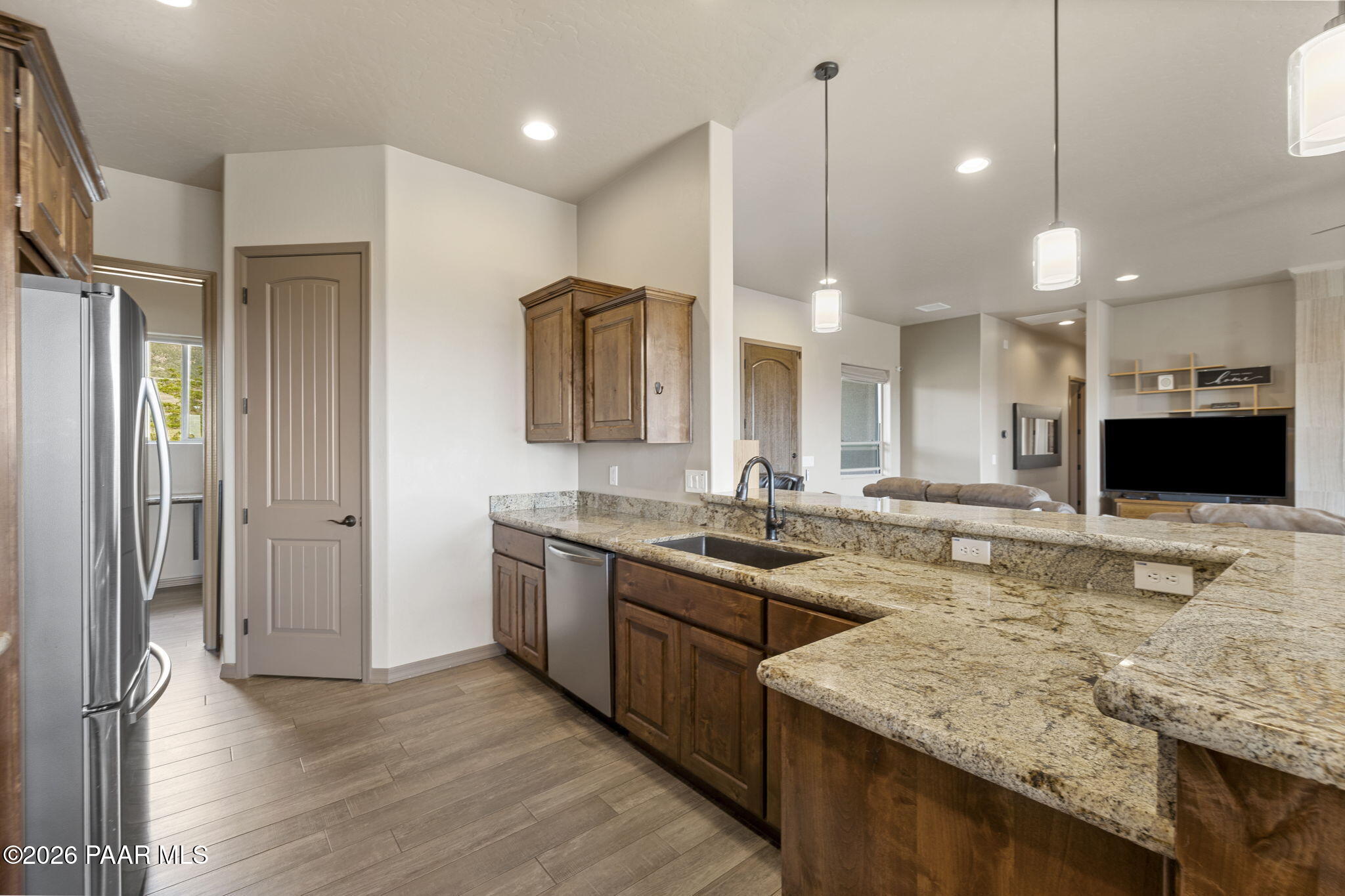 14141 Cassidy Trail Prescott Valley, AZ 86315 - Photo 12 of 44 a kitchen with stainless steel appliances granite countertop a sink a stove and a wooden floors