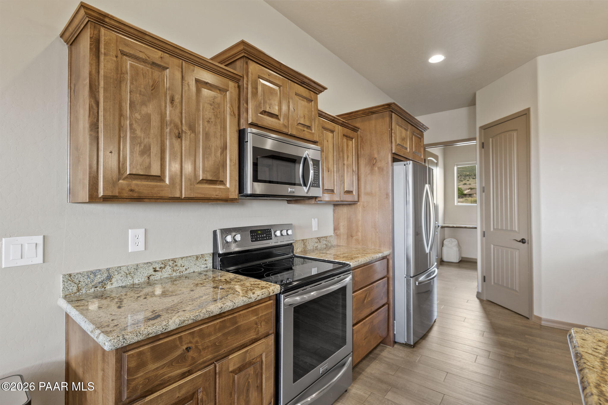 14141 Cassidy Trail Prescott Valley, AZ 86315 - Photo 13 of 44 a kitchen with stainless steel appliances granite countertop a refrigerator and microwave