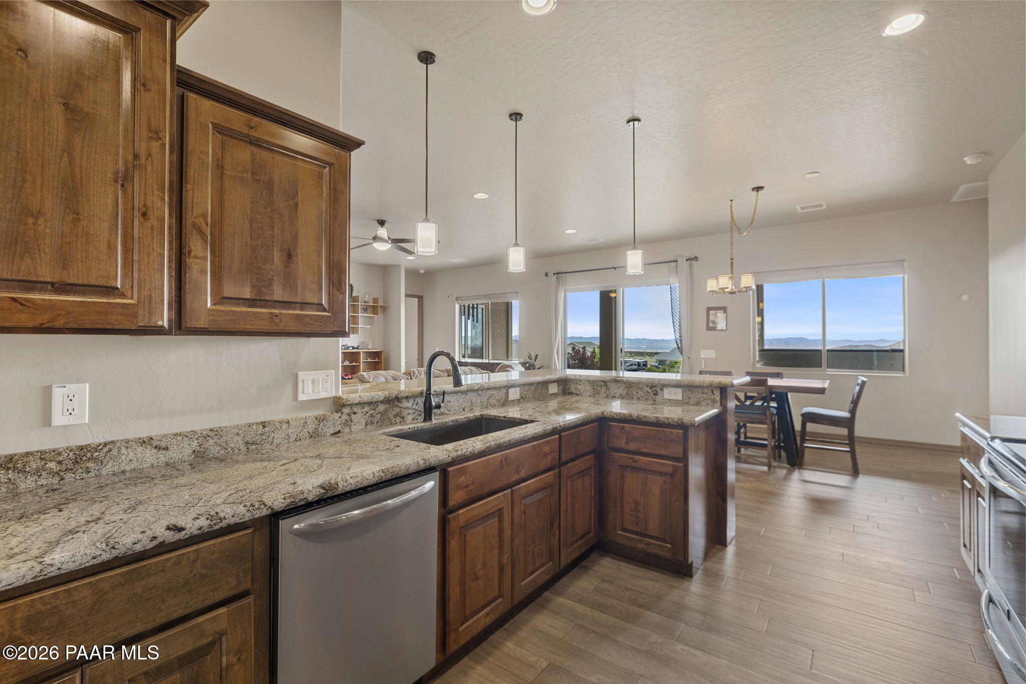 14141 Cassidy Trail Prescott Valley, AZ 86315 - Photo 14 of 44 a kitchen with lots of counter top space and wooden floor
