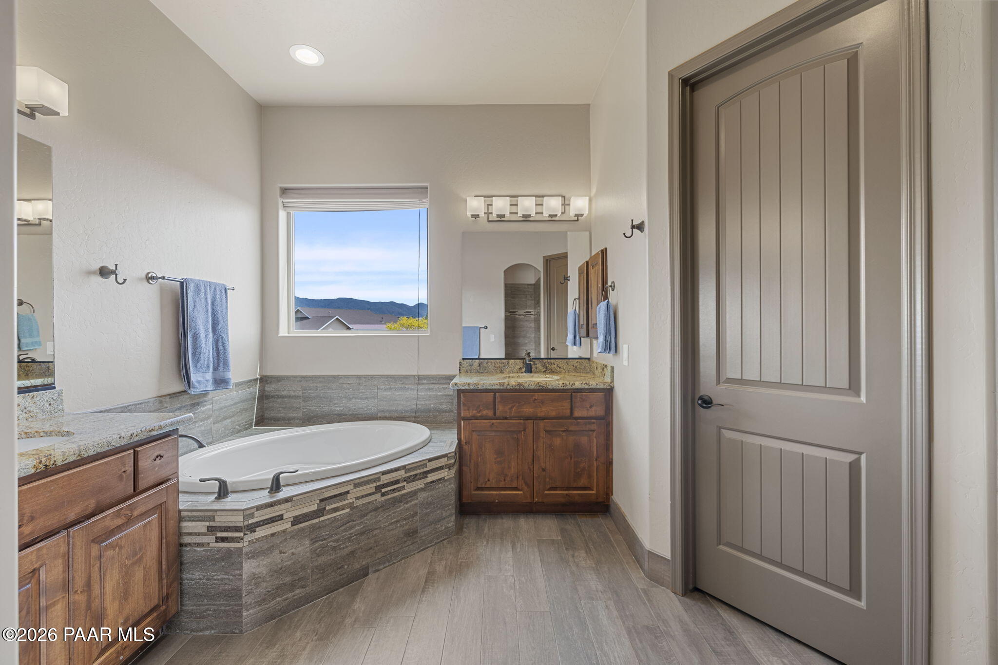 14141 Cassidy Trail Prescott Valley, AZ 86315 - Photo 19 of 44 a spacious bathroom with a granite countertop tub sink and mirror