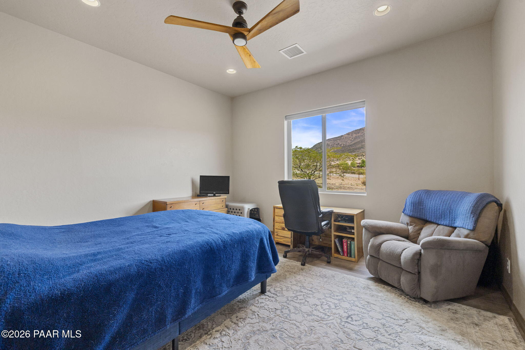 14141 Cassidy Trail Prescott Valley, AZ 86315 - Photo 24 of 44 a bedroom with a bed and a chair