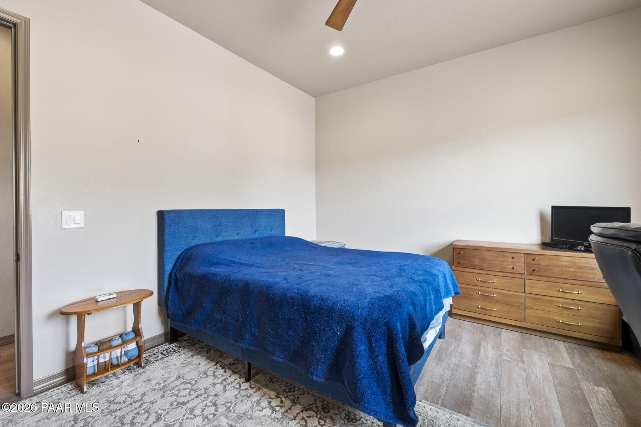 14141 Cassidy Trail Prescott Valley, AZ 86315 - Photo 25 of 44 a bedroom with a bed and wooden floor