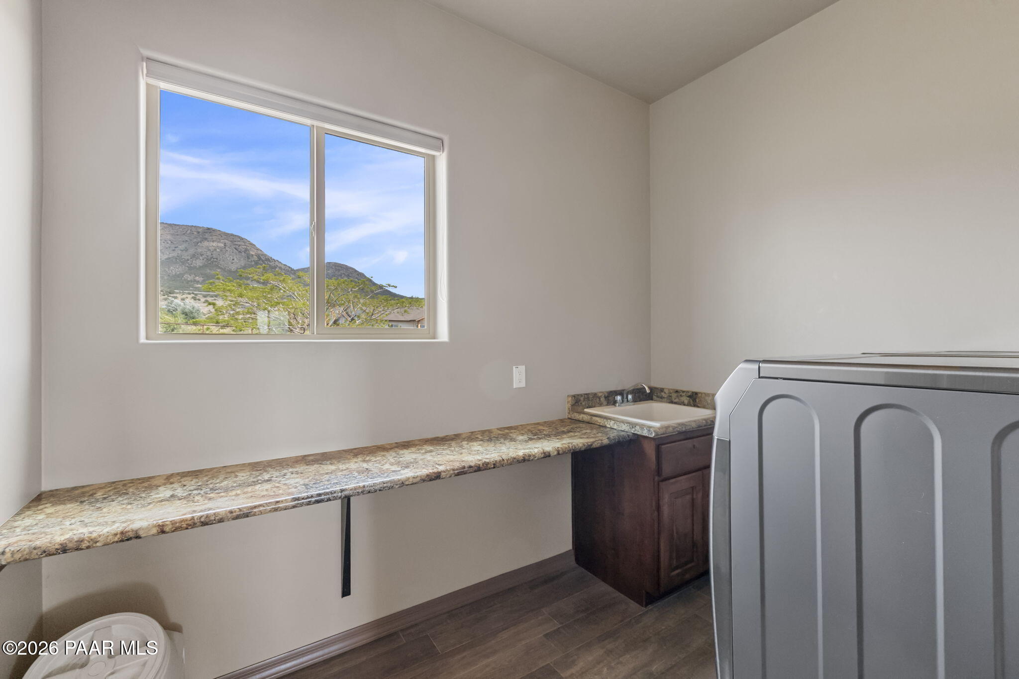 14141 Cassidy Trail Prescott Valley, AZ 86315 - Photo 27 of 44 a utility room with a sink a window and a wooden floor