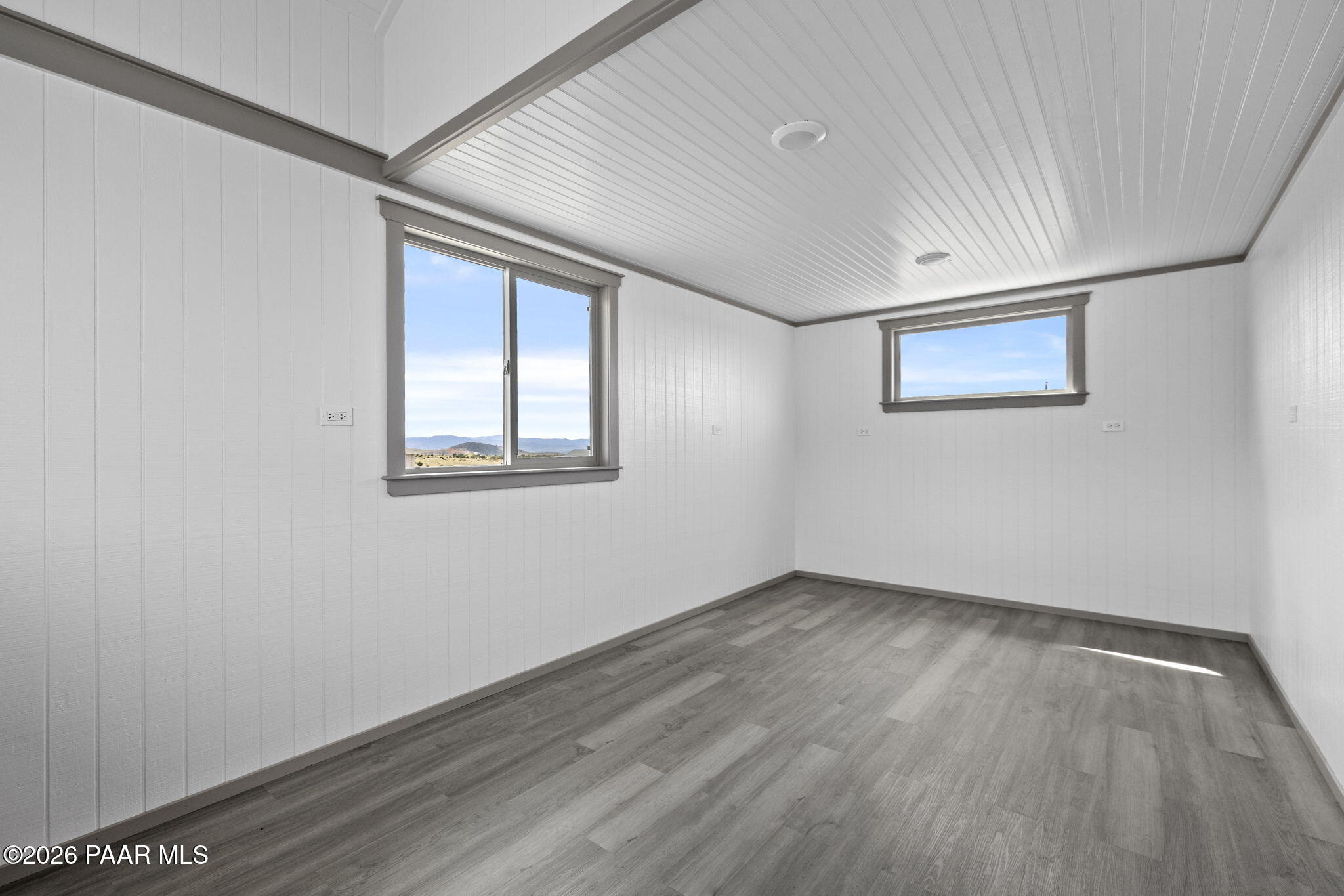 14141 Cassidy Trail Prescott Valley, AZ 86315 - Photo 38 of 44 an empty room with wooden floor and windows