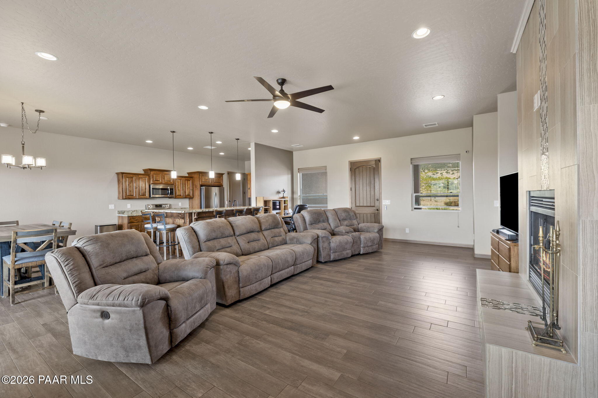 14141 Cassidy Trail Prescott Valley, AZ 86315 - Photo 5 of 44 a living room with furniture kitchen view and a wooden floor