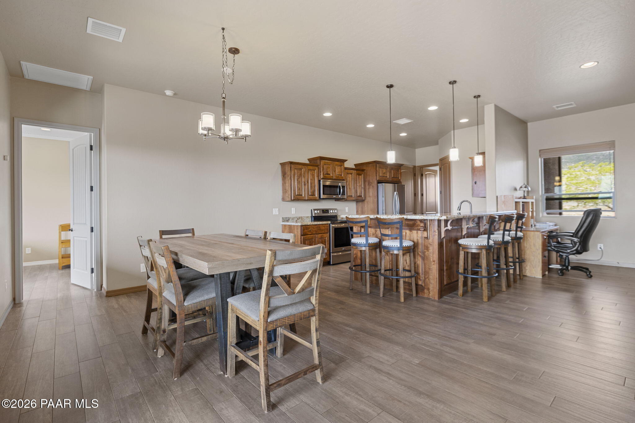 14141 Cassidy Trail Prescott Valley, AZ 86315 - Photo 10 of 44 a view of a dining area with furniture and wooden floor