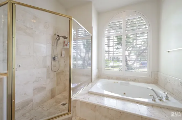 a bathroom with a tub shower and sink