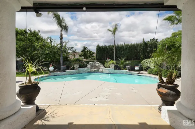 a view of a swimming pool with a yard