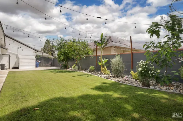 an aerial view of a house with a yard and garden