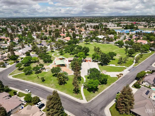 an aerial view of residential houses with city view