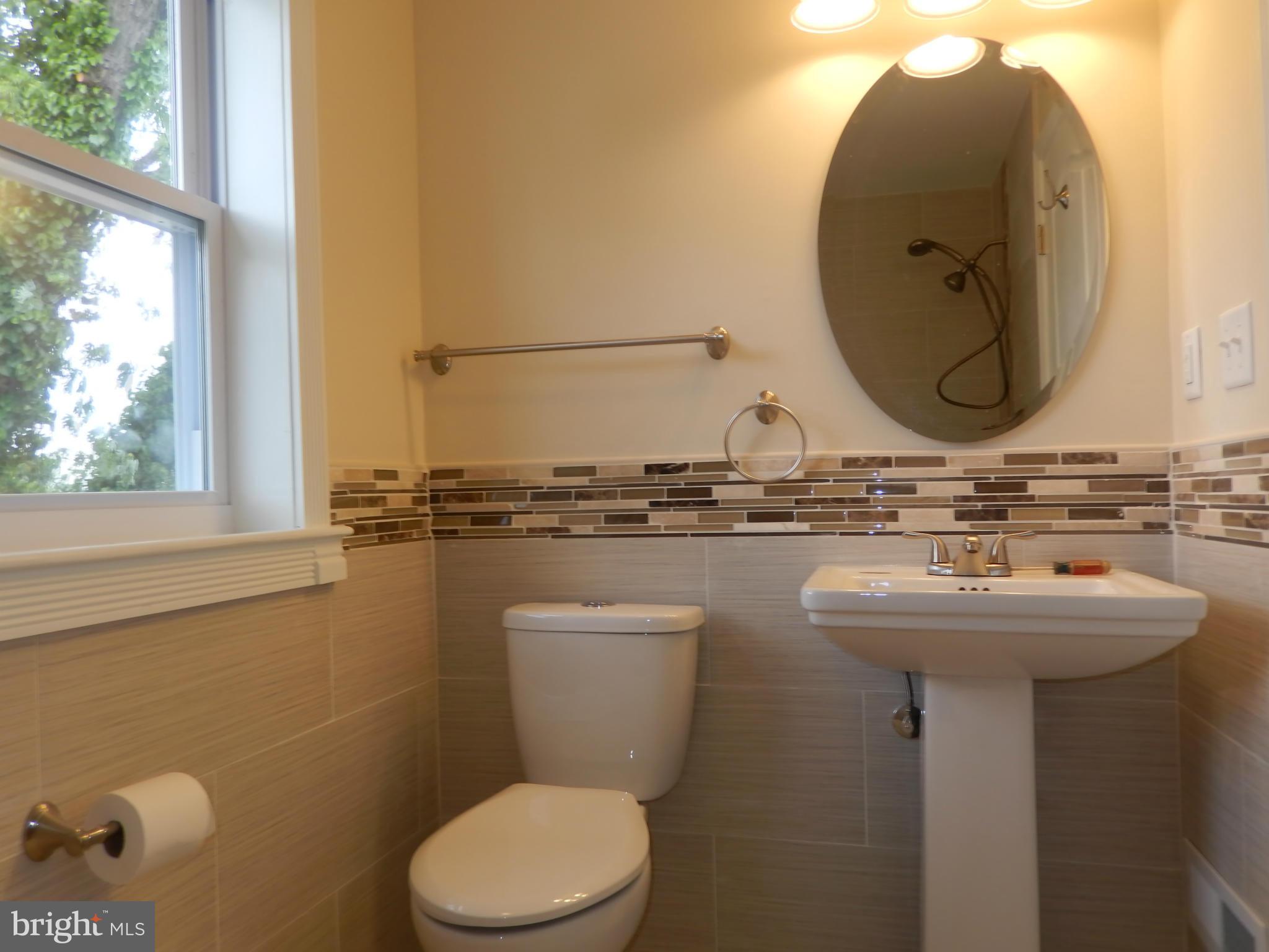 622 Charraway Road Baltimore, MD 21229 - Photo 20 of 28 a bathroom with a toilet sink and mirror