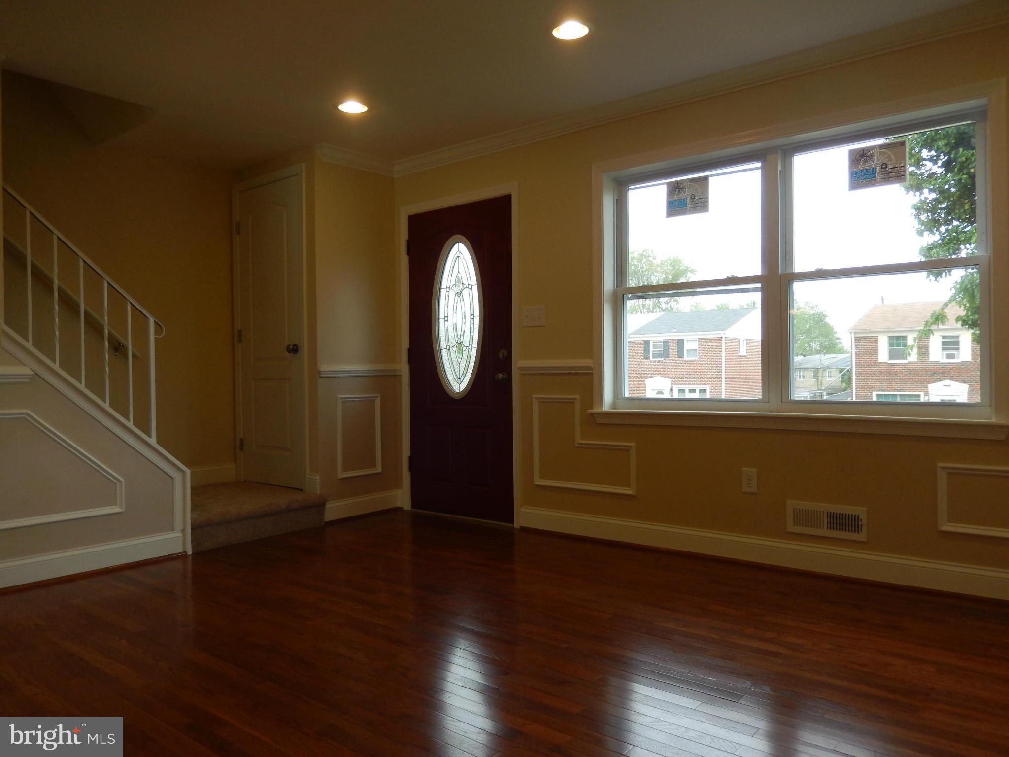 622 Charraway Road Baltimore, MD 21229 - Photo 3 of 28 a view of empty room with wooden floor and fan